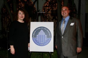 SCOLA Executive Director Fabiola Vilchez and Sister Cities International SoCal President Anthony Al-Jamie with the new logo for Sister Cities of Los Angeles
